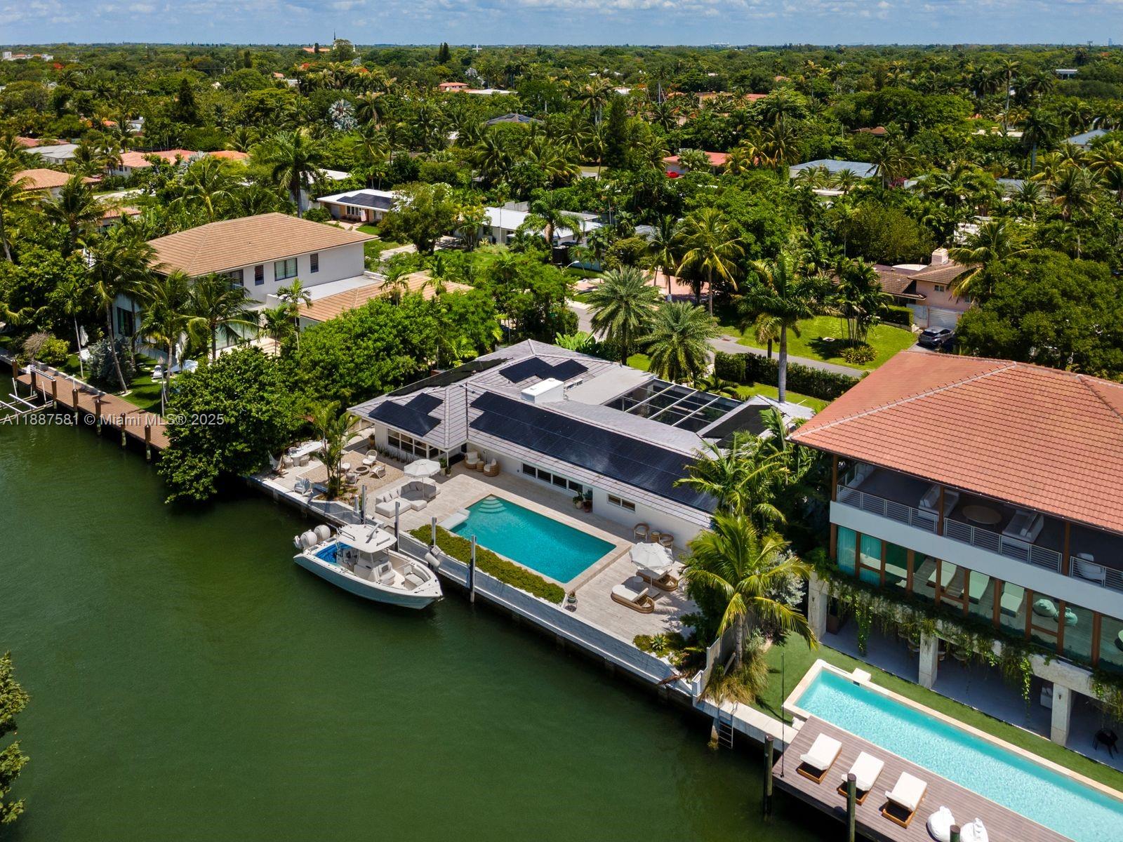 1250 Northeast 87th Street Miami, FL 33138 - Photo 48 of 53 an aerial view of a house with a garden and lake view
