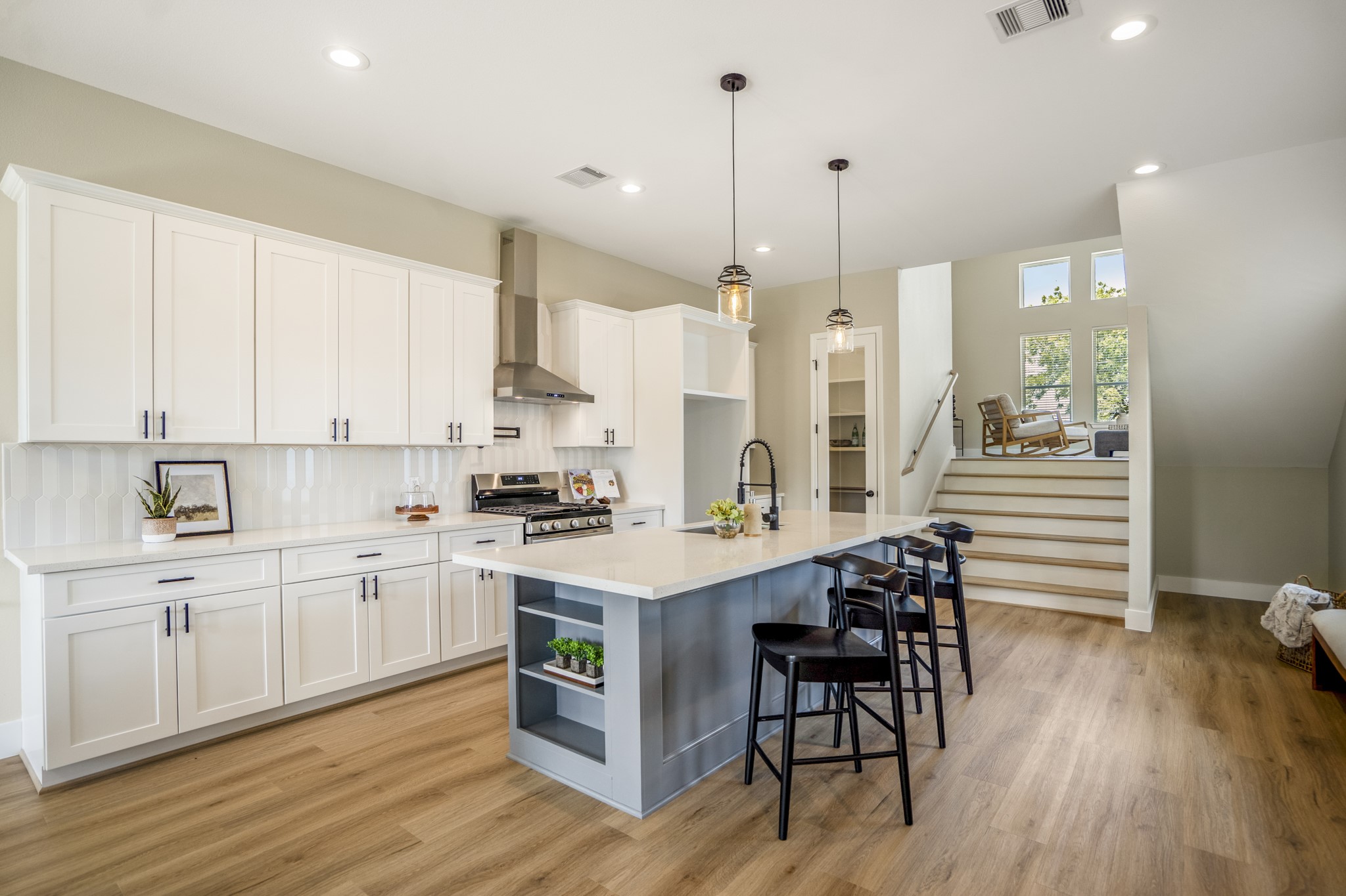 4101 East Rogers Street Houston, TX 77022 - Photo 11 of 42 a kitchen with stainless steel appliances kitchen island wooden floors and white cabinets