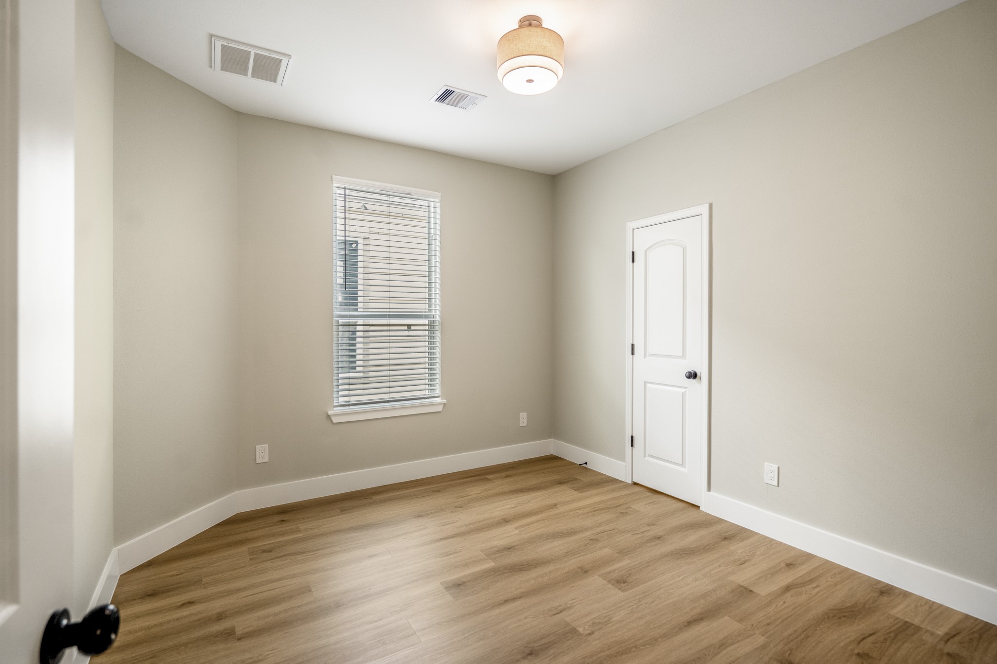 4101 East Rogers Street Houston, TX 77022 - Photo 35 of 42 a view of an empty room with wooden floor and a window