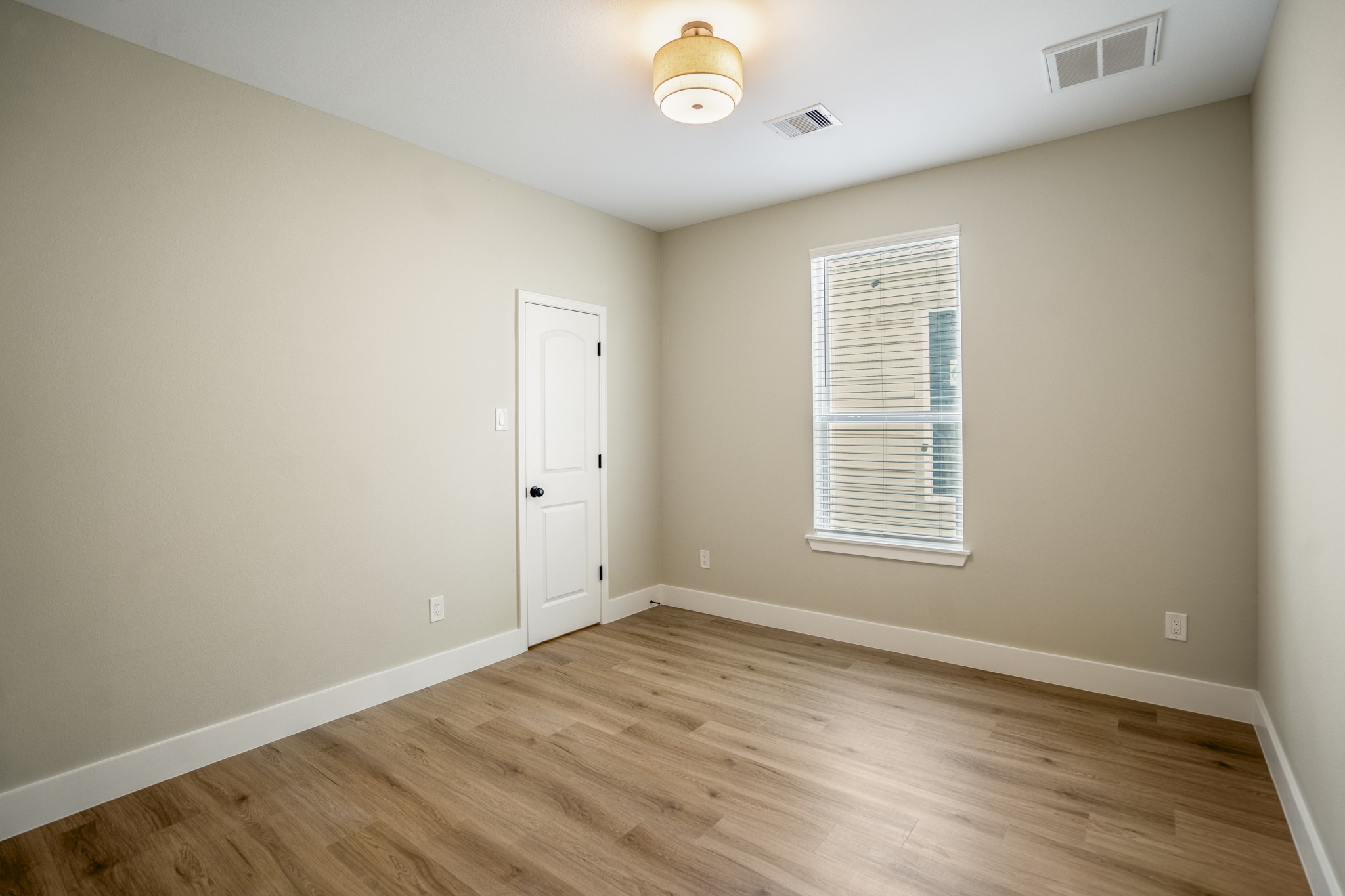 4101 East Rogers Street Houston, TX 77022 - Photo 36 of 42 a view of an empty room with wooden floor and a window