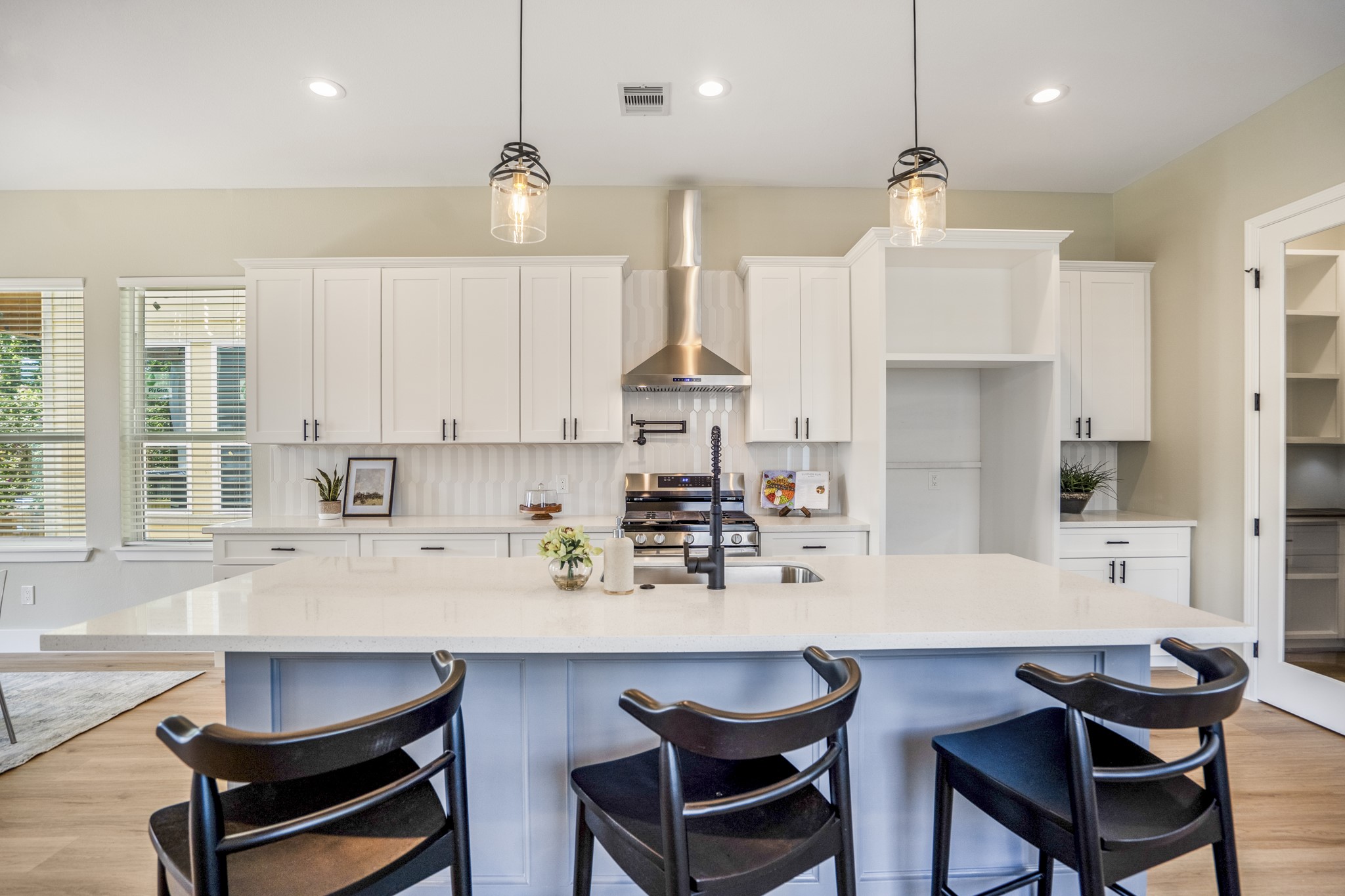 4101 East Rogers Street Houston, TX 77022 - Photo 7 of 42 a kitchen with kitchen island granite countertop a dining table chairs cabinets and stainless steel appliances