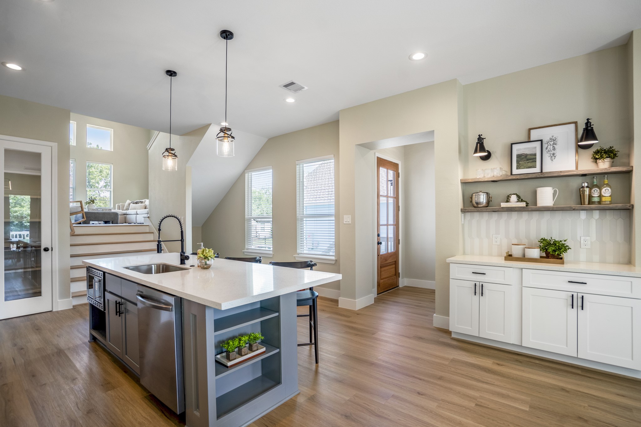 4101 East Rogers Street Houston, TX 77022 - Photo 9 of 42 a large kitchen with stainless steel appliances a stove a sink dishwasher and a dining table with wooden floor