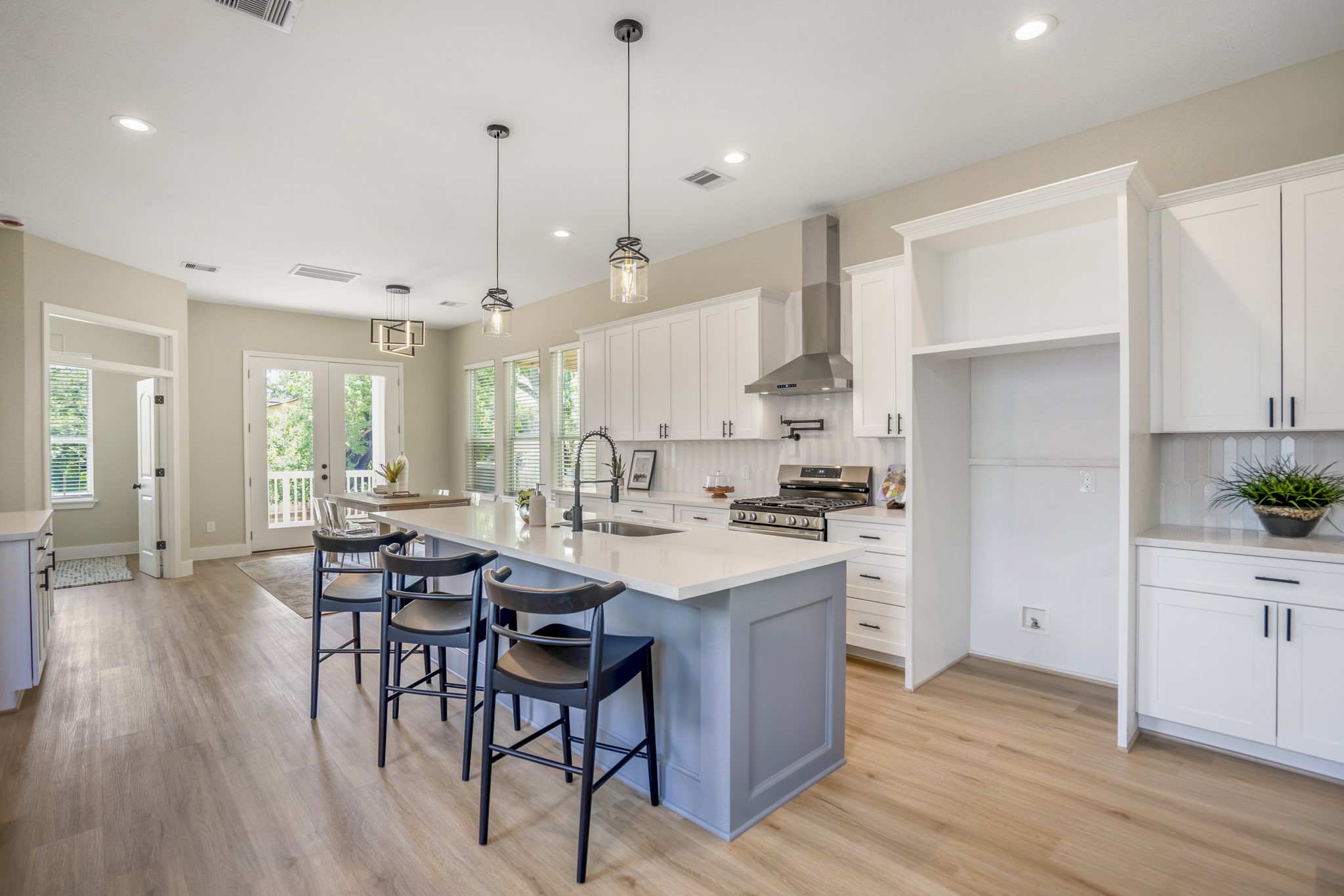 4101 East Rogers Street Houston, TX 77022 - Photo 10 of 42 a kitchen with stainless steel appliances a dining table chairs stove refrigerator and cabinets