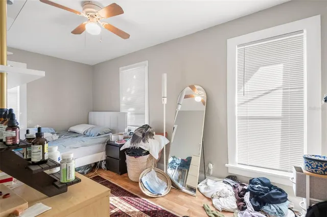 a living room with patio furniture and a chandelier