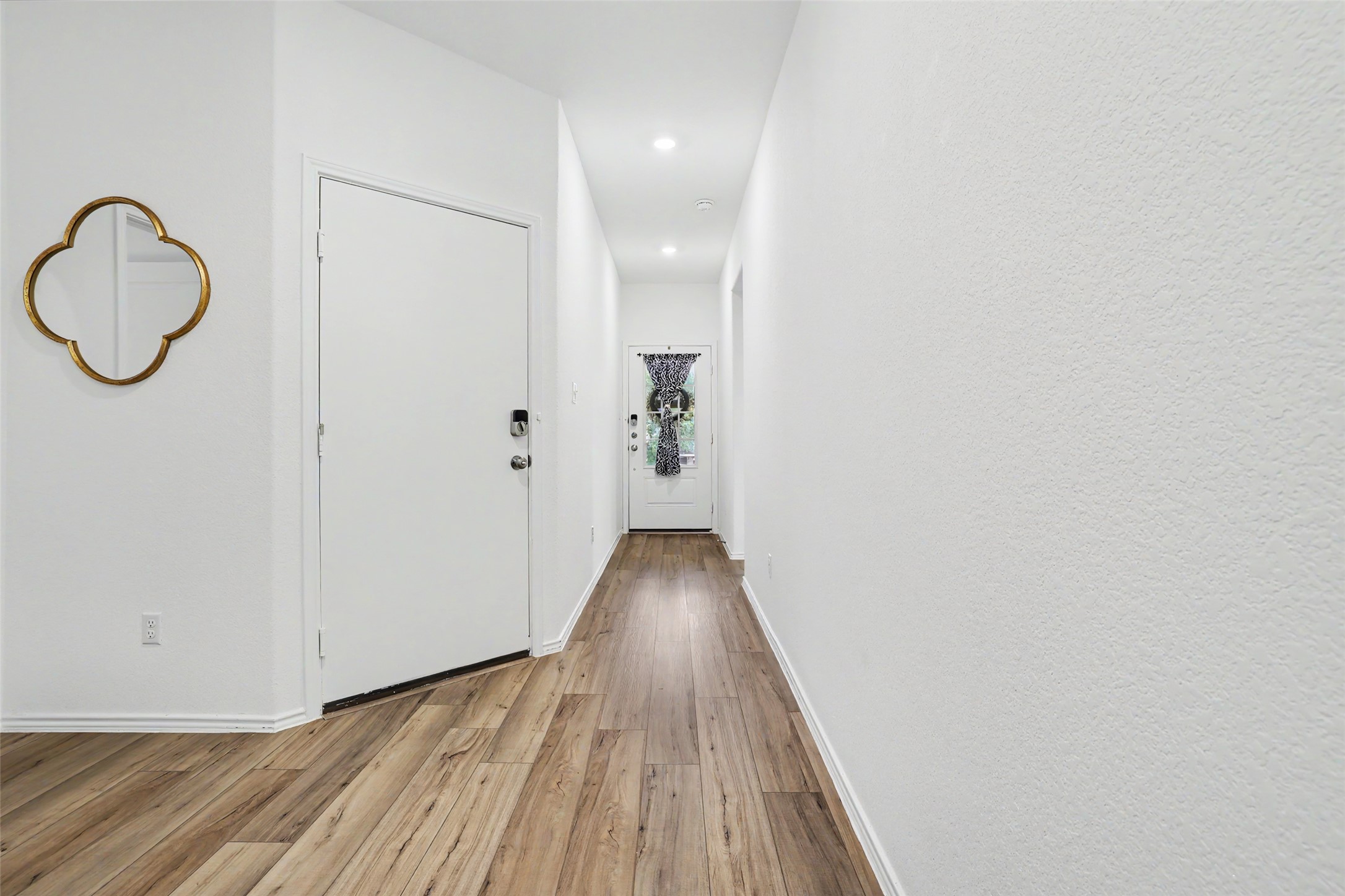 2333 Four Waters Loop Georgetown, TX 78628 - Photo 4 of 35 Hallway with wood-finish flooring, white walls, and recessed lighting