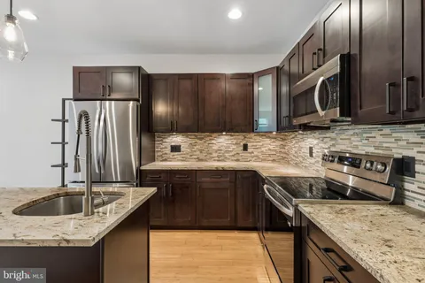 a kitchen that has a sink a window and appliances