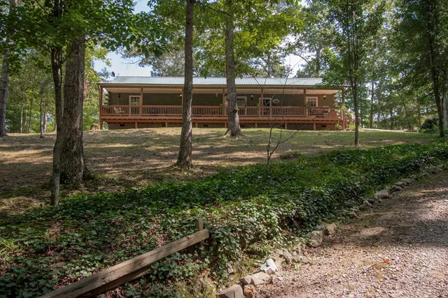 a view of a backyard with wooden fence