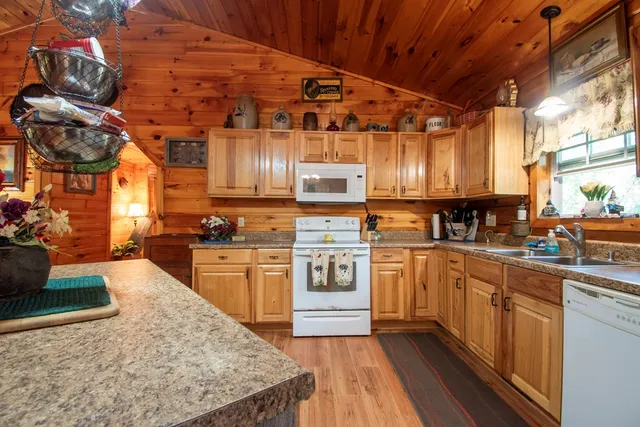a kitchen with stainless steel appliances granite countertop a sink and cabinets