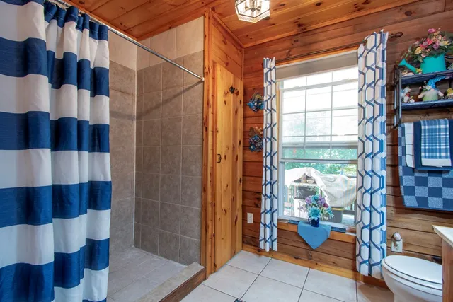 a hallway with a couch and chandelier