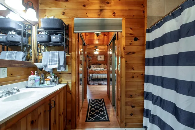 a view of a hallway with wooden floor and furniture