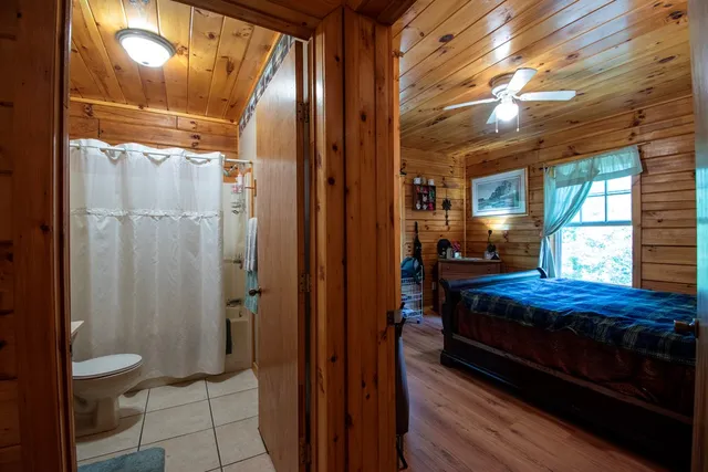 a bedroom with a bed and a mirror