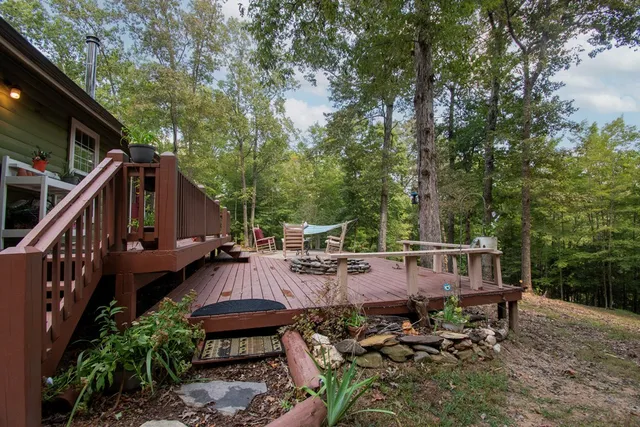 a front view of a house with a garden and trees