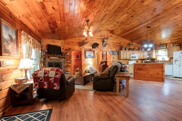 a living room with fireplace furniture and a wooden floor