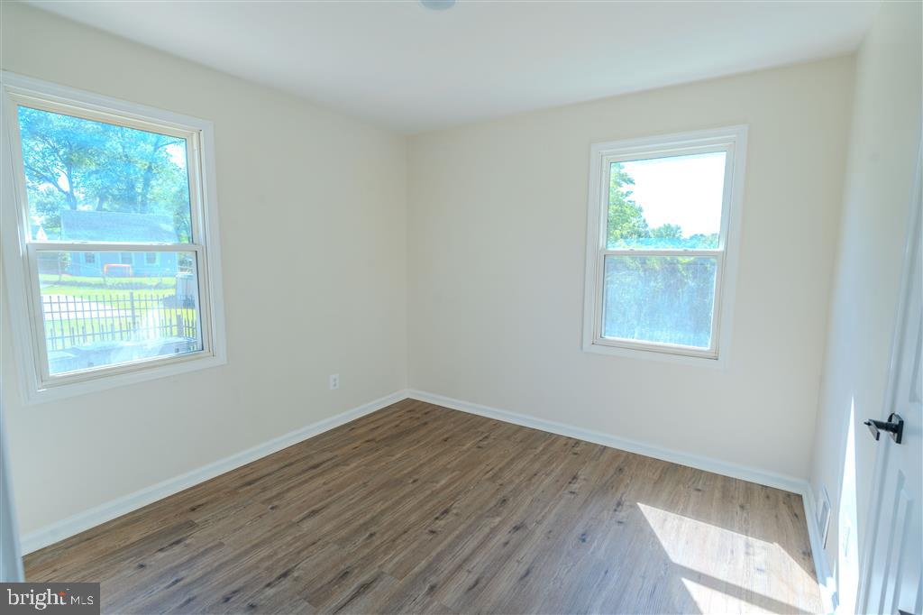 12324 Centerhill Street Silver Spring, MD 20902 - Photo 13 of 24 an empty room with wooden floor and windows