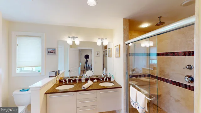 a bathroom with a granite countertop sink and mirror