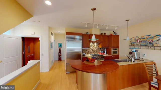 a living room with furniture a flat screen tv and gym equipment