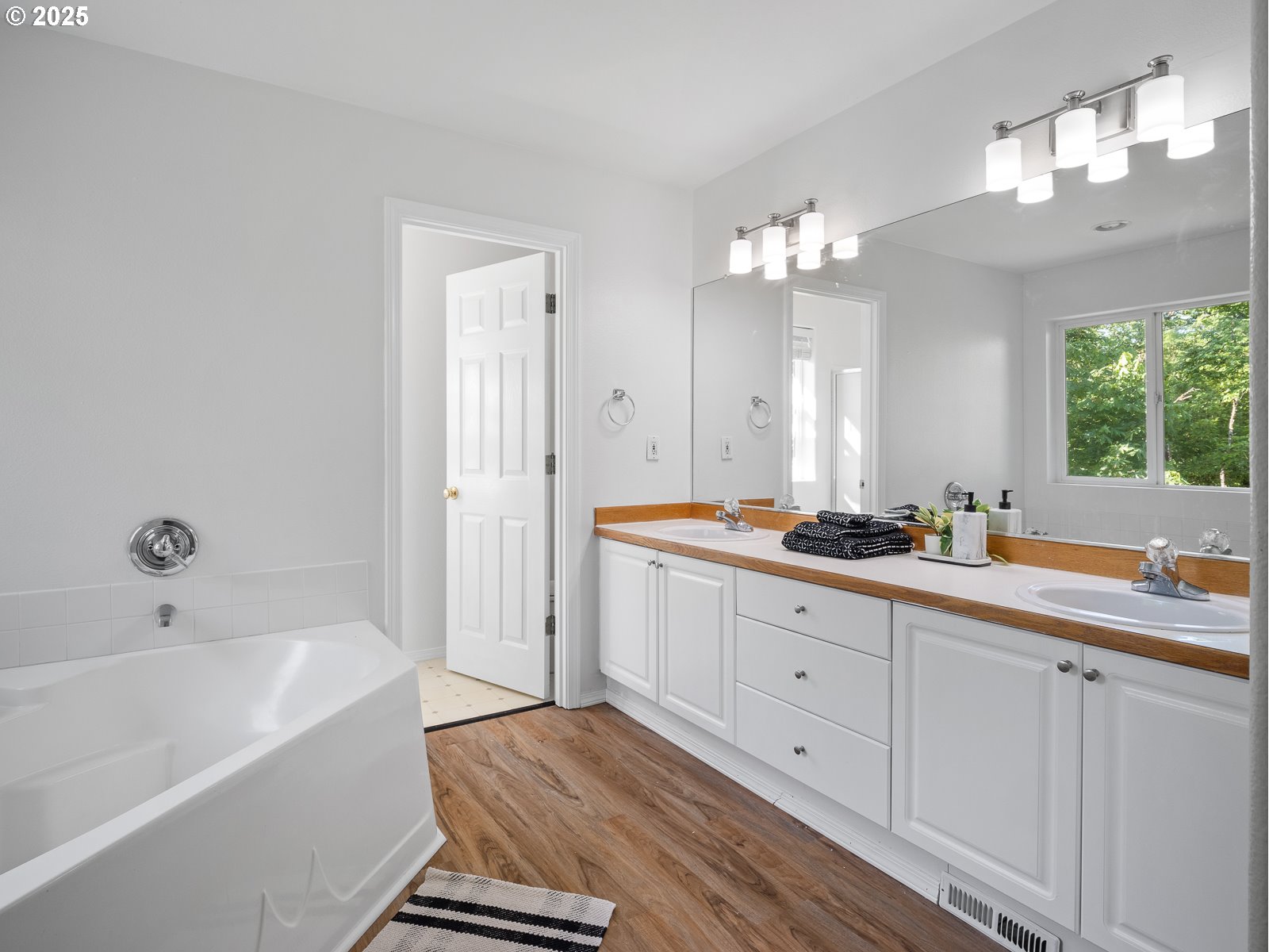 68 Southeast 47th Circle Gresham, OR 97080 - Photo 17 of 30 a spacious bathroom with a double vanity sink a mirror and a bathtub