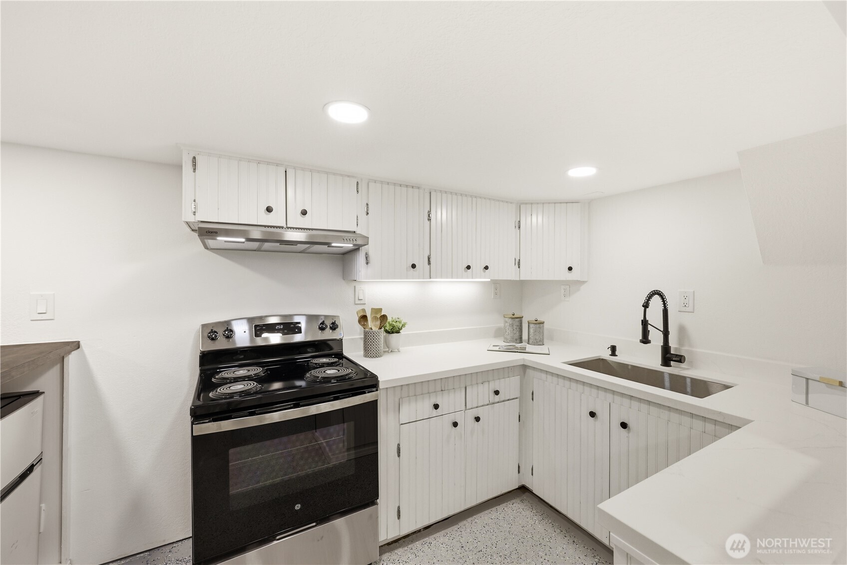 9011 36th Avenue Southwest Seattle, WA 98126 - Photo 32 of 40 a kitchen with cabinets stainless steel appliances a sink and a counter top space