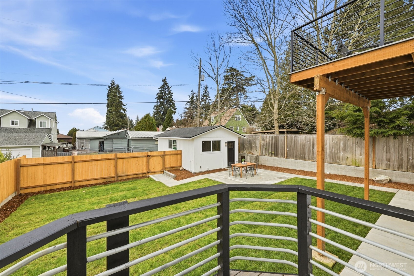 9011 36th Avenue Southwest Seattle, WA 98126 - Photo 37 of 40 a view of a house with a backyard porch and sitting area