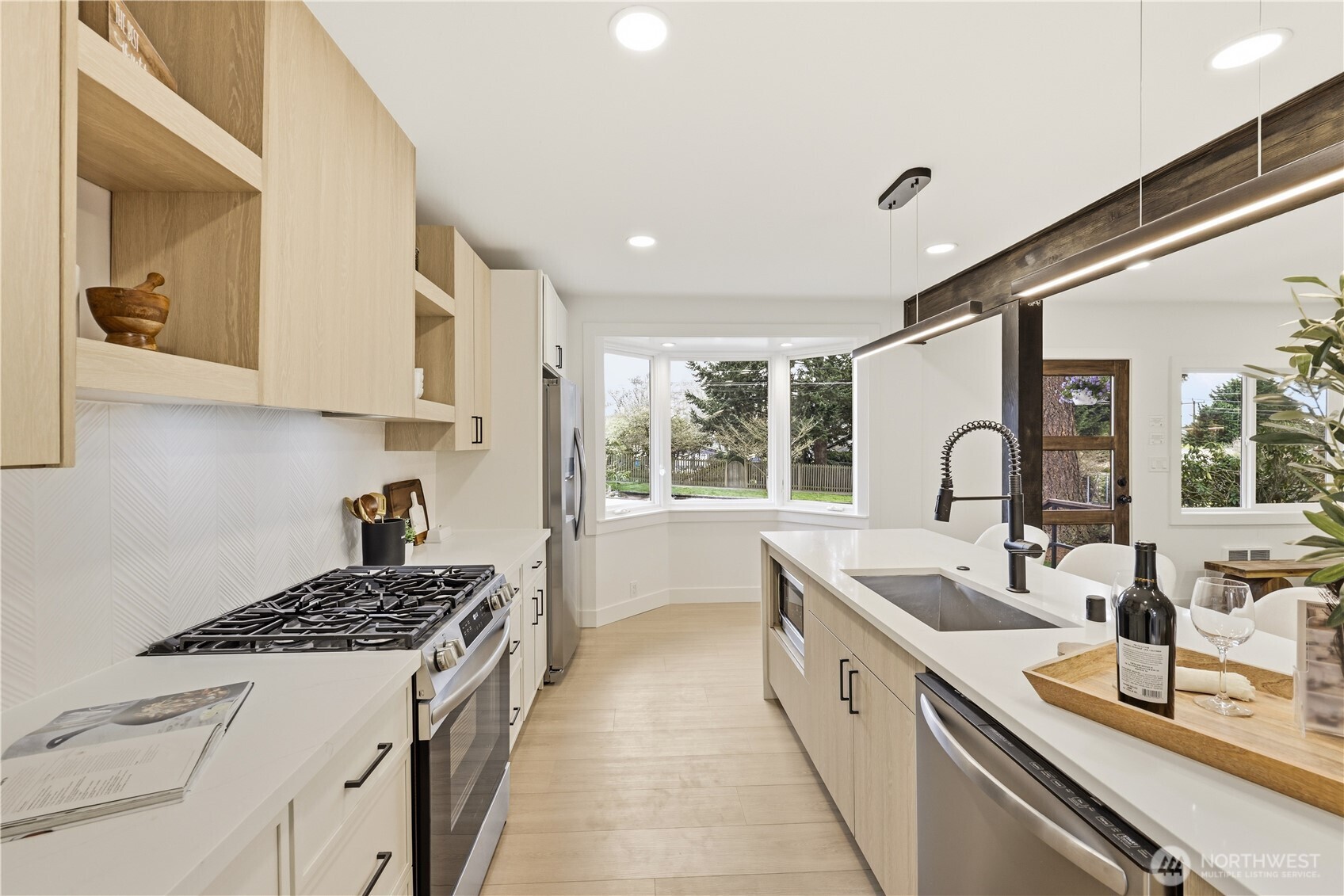 9011 36th Avenue Southwest Seattle, WA 98126 - Photo 8 of 40 a kitchen with sink a stove and cabinets