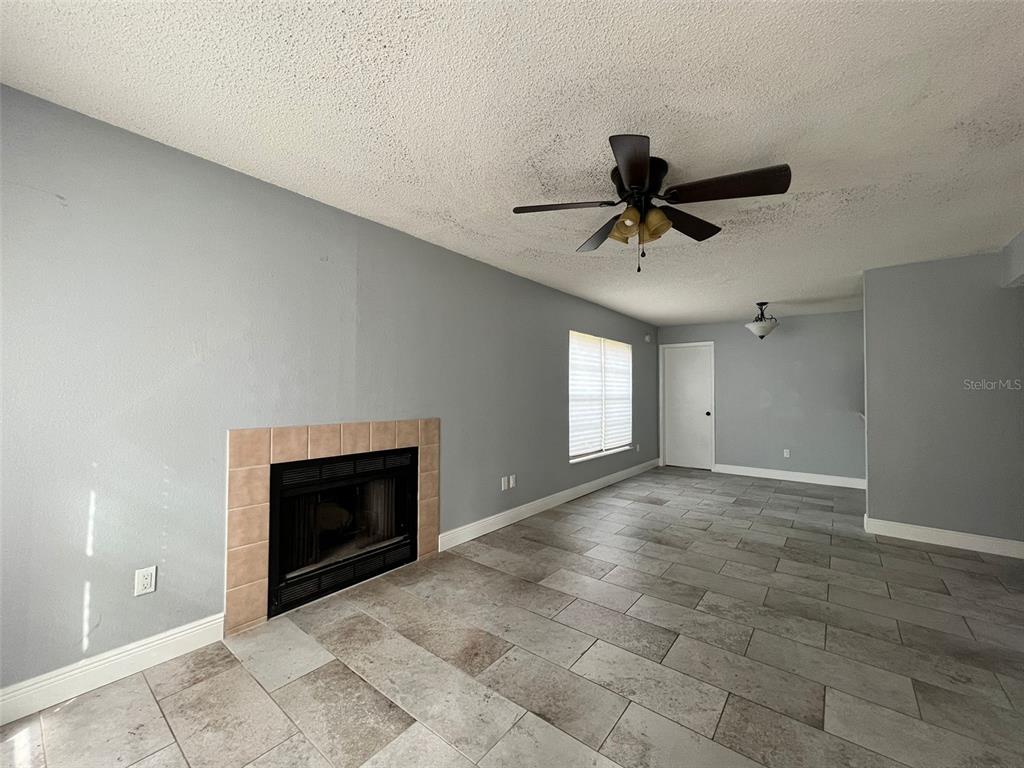 3964 Dream Oak Place, Unit 104 Tampa, FL 33613 - Photo 2 of 11 a view of a livingroom with a ceiling fan and window