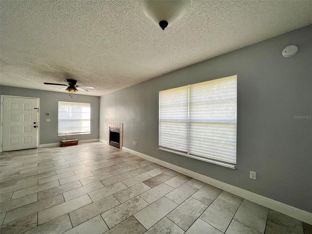 3964 Dream Oak Place, Unit 104 Tampa, FL 33613 - Photo 3 of 11 an empty room with windows and fireplace