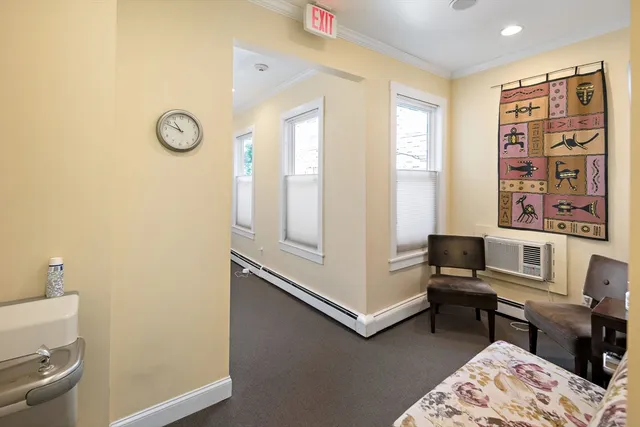 a view of a workspace with furniture and a window