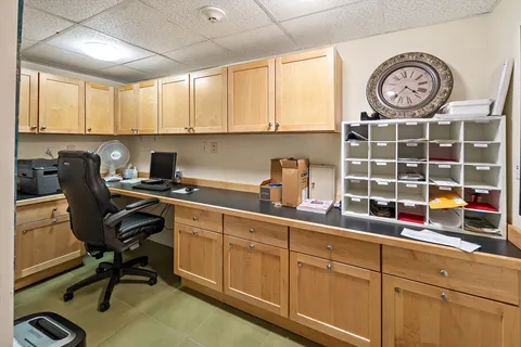 a kitchen with a cabinets and a clock on the wall