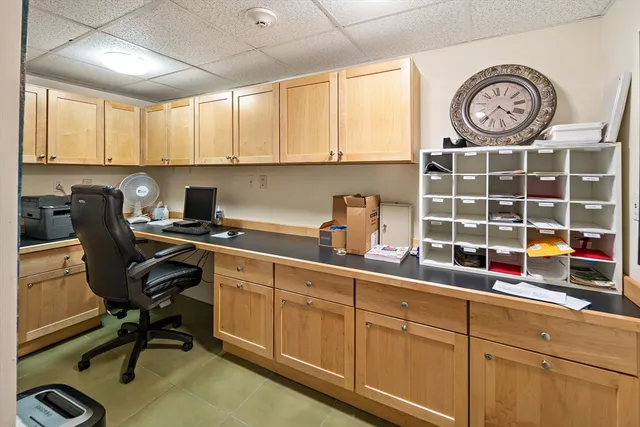 a kitchen with a cabinets and a clock on the wall