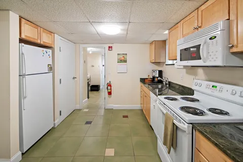 a kitchen with stainless steel appliances granite countertop a stove a refrigerator and a refrigerator