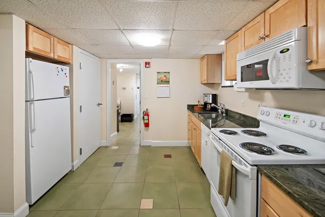 a kitchen with stainless steel appliances granite countertop a stove a refrigerator and a refrigerator