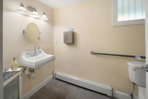 a bathroom with a sink a mirror and vanity