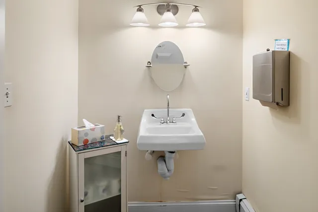 a bathroom with a sink and mirror