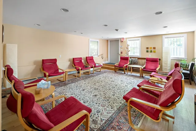 a living room with furniture and red walls