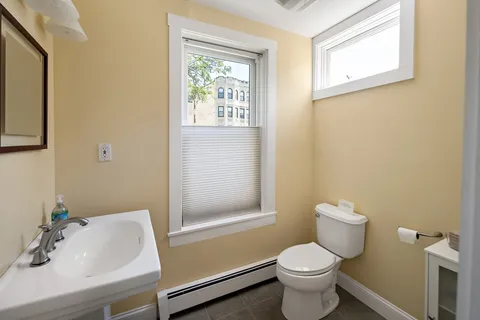 a white toilet sitting next to a bathroom sink