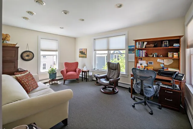a living room with furniture a window and a flat screen tv