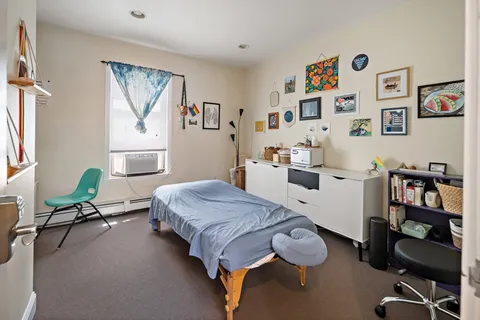 a bedroom with furniture and a window
