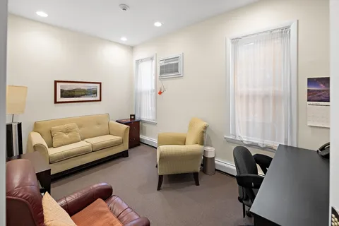 a living room with furniture a couch and a window