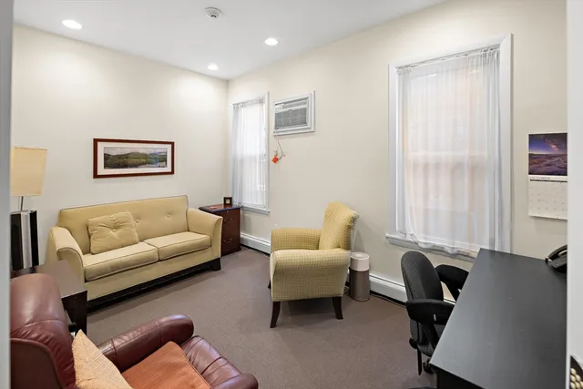 a living room with furniture a couch and a window