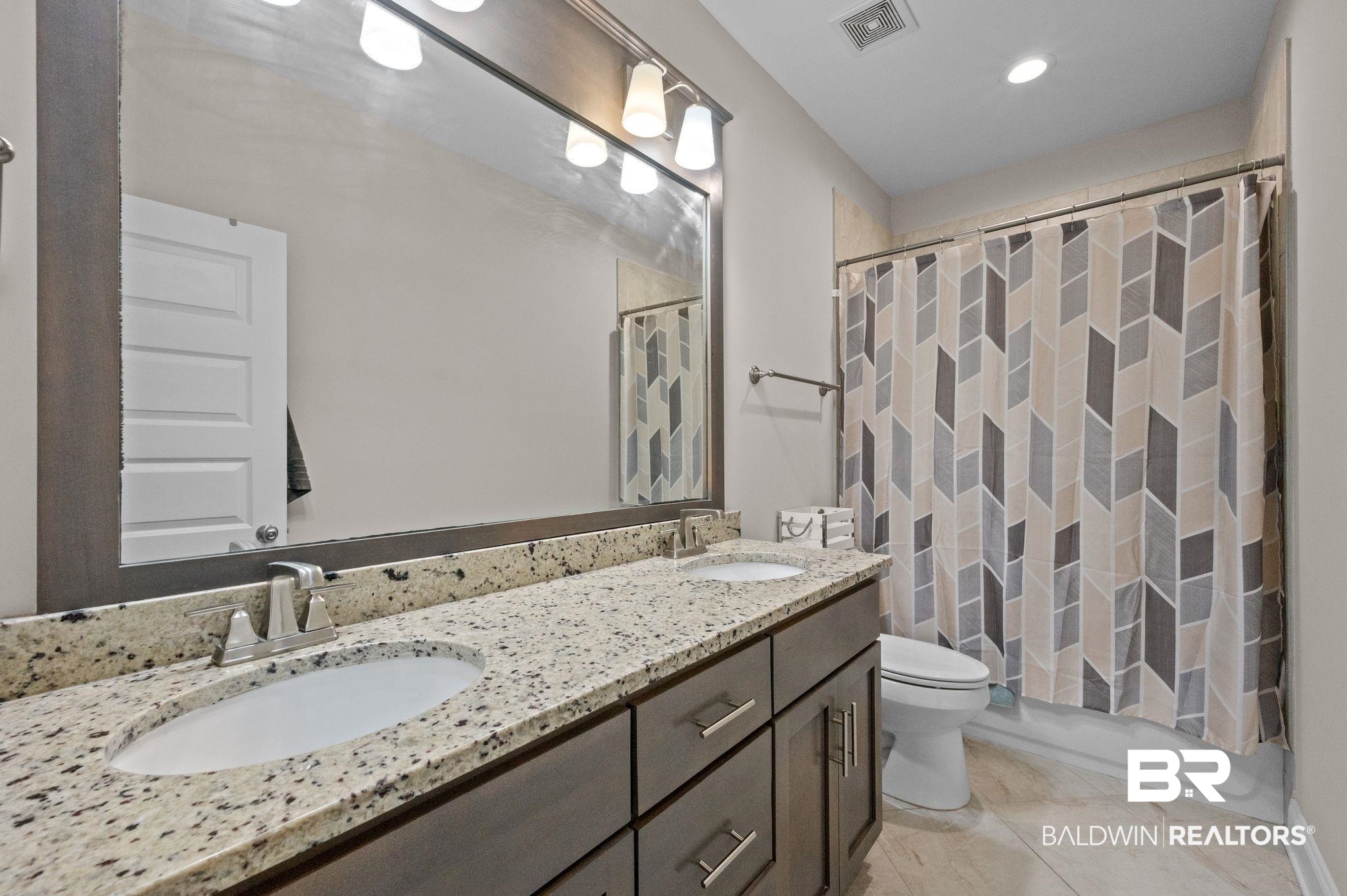 32194 Badger Court Daphne, AL 36527 - Photo 36 of 49 Full bath with double vanity, shower / bath combination with curtain, and recessed lighting