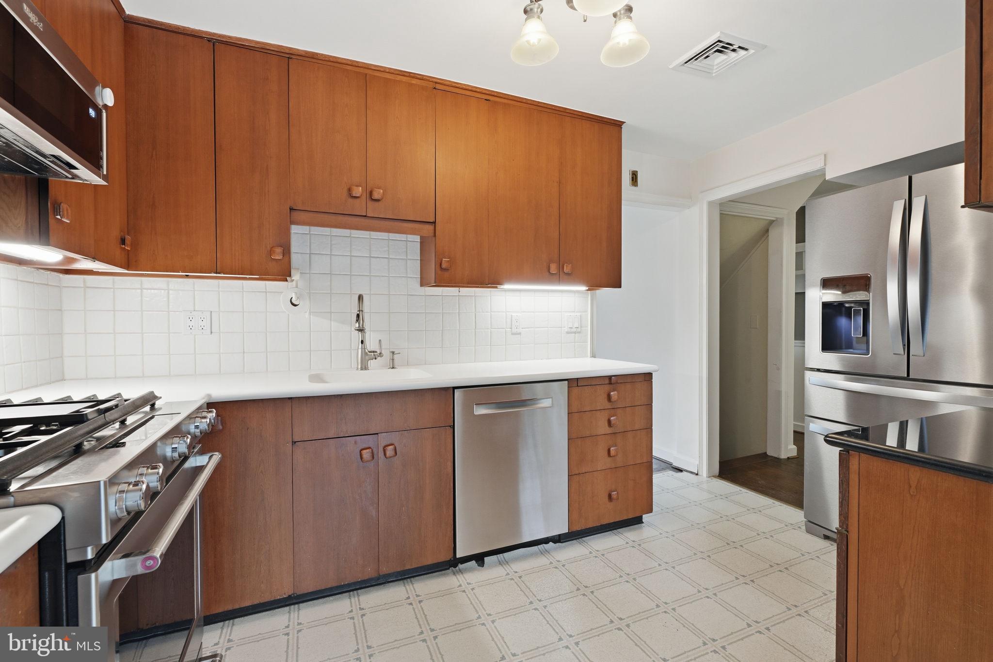 404 Old Farm Road Wyncote, PA 19095 - Photo 14 of 41 Modern kitchen with warm wood tones.