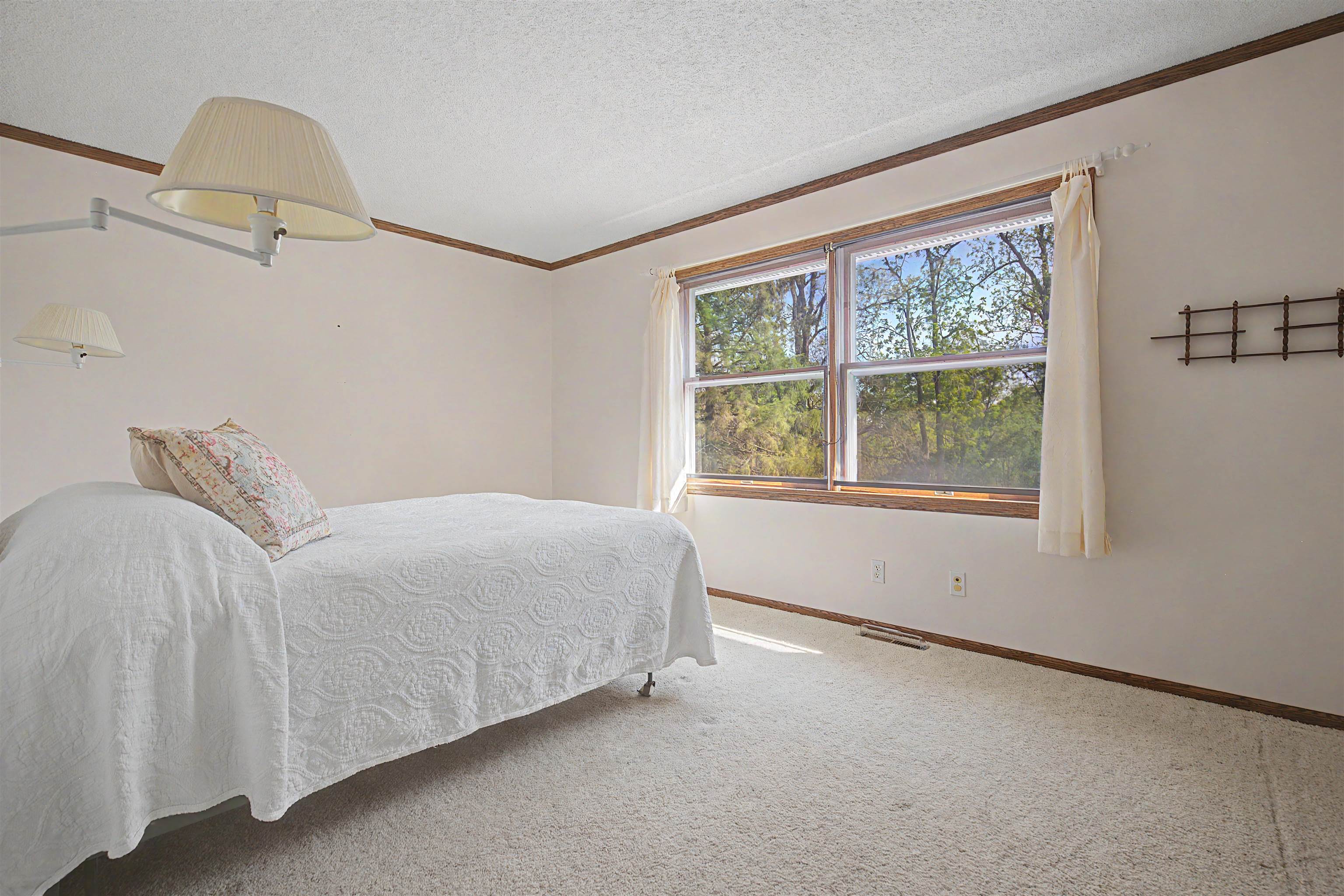 17380 Corbett Road Mount Carroll, IL 61053 - Photo 19 of 65 a bedroom with a bed and a window