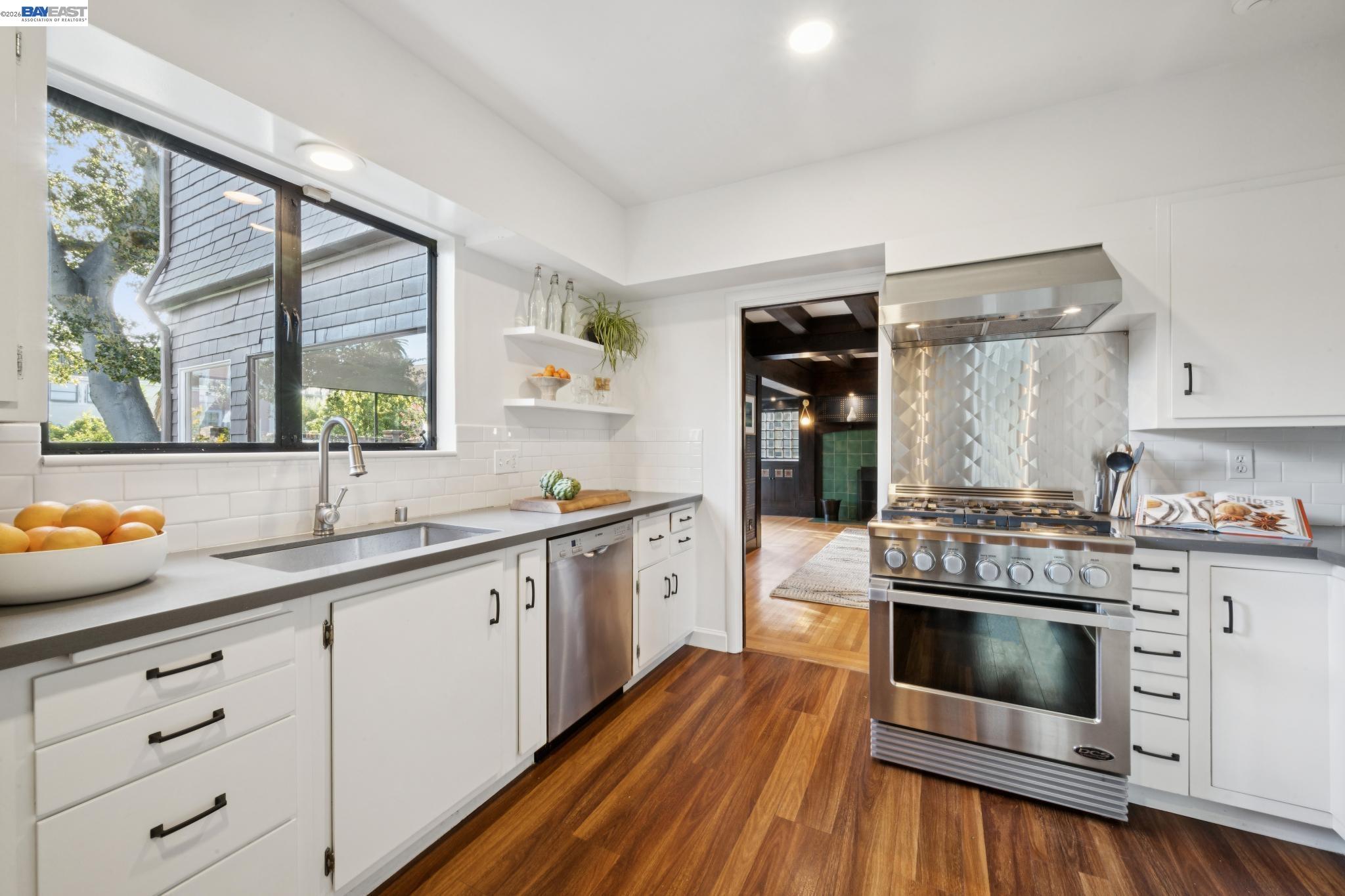 1122 Bay Street Alameda, CA 94501 - Photo 27 of 60 a kitchen with white cabinets and white appliances