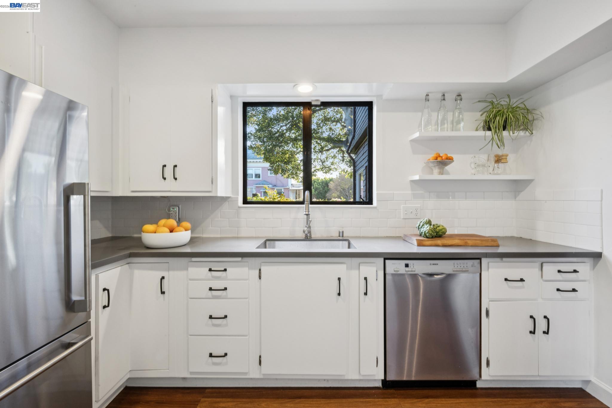 1122 Bay Street Alameda, CA 94501 - Photo 28 of 60 a kitchen with stainless steel appliances granite countertop a refrigerator a sink and wooden floors