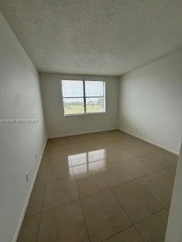 an empty room with a empty space and windows