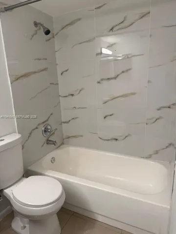 a bathroom with a toilet and a bathtub