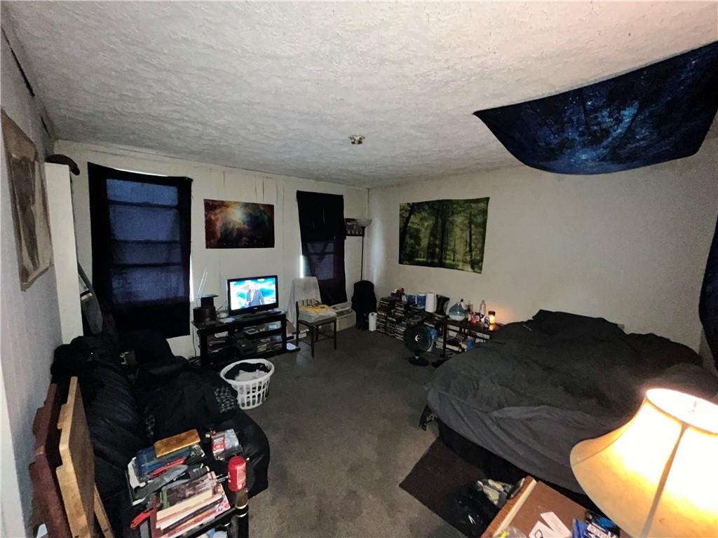 5154-5158 Natrona Way Pittsburgh, PA 15201 - Photo 24 of 46 a living room with furniture and a flat screen tv