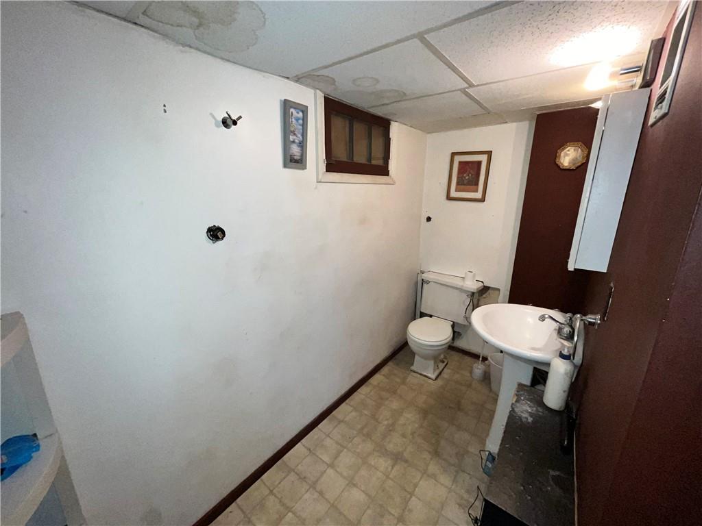 5154-5158 Natrona Way Pittsburgh, PA 15201 - Photo 26 of 46 a bathroom with a toilet sink and mirror