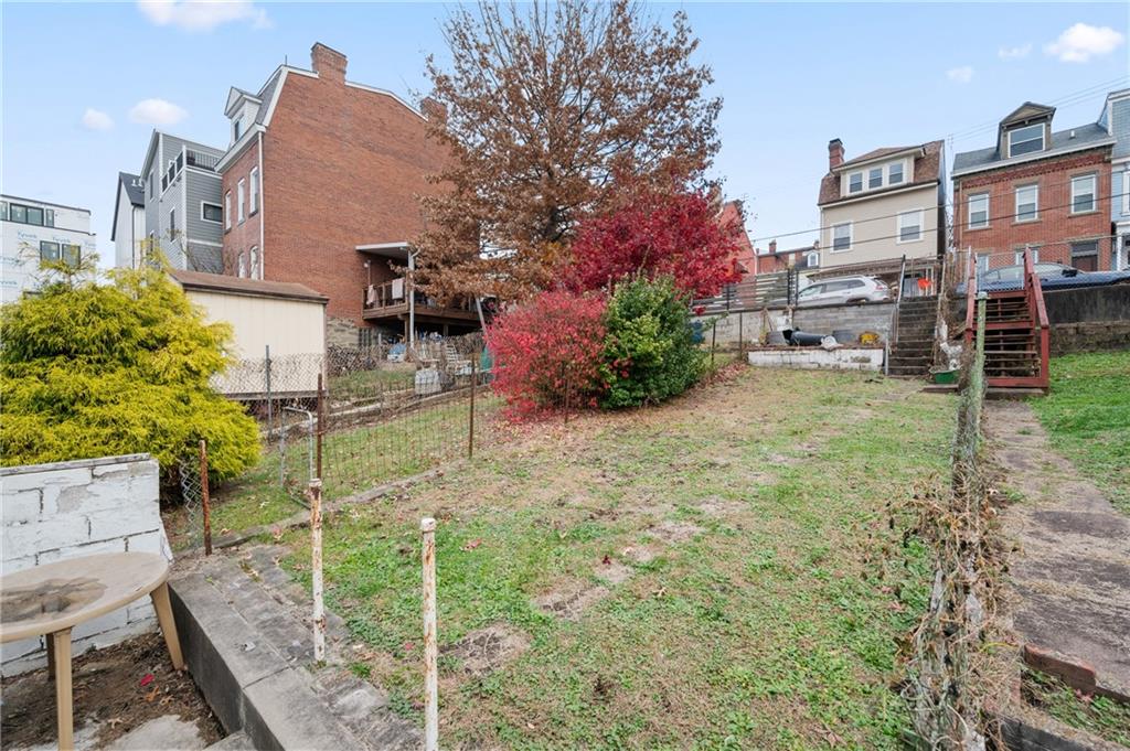 5154-5158 Natrona Way Pittsburgh, PA 15201 - Photo 31 of 46 a backyard of a house with lots of green space and fountain