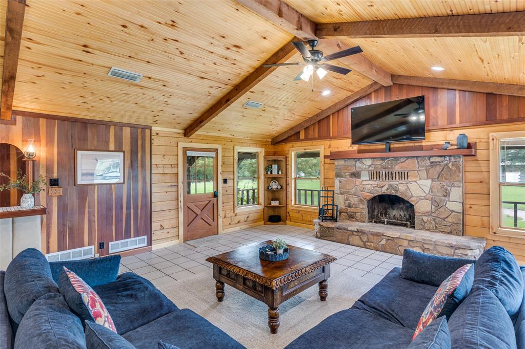 779 County Road 1971 Yantis, TX 75497 - Photo 11 of 40 a living room with furniture a flat screen tv and a fireplace